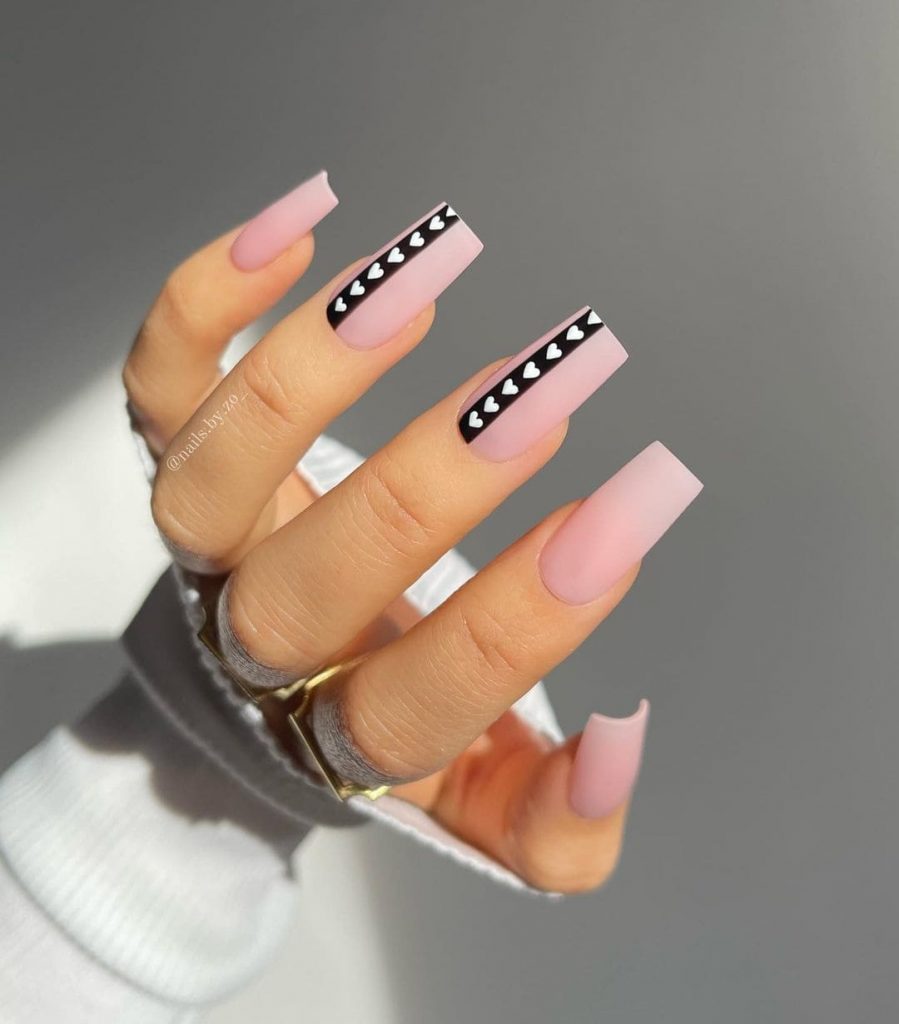These beautiful Pink nails with black and white heart highlights will be perfect for your valentine plans