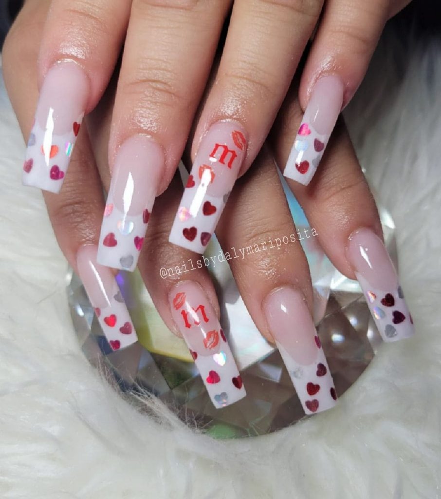 The simple heart nail design looks beautiful when done like a band for a French nail appearance